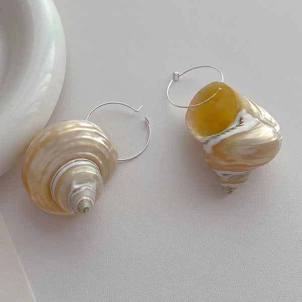 Shell hoop earrings with a natural finish, beach-inspired accessory