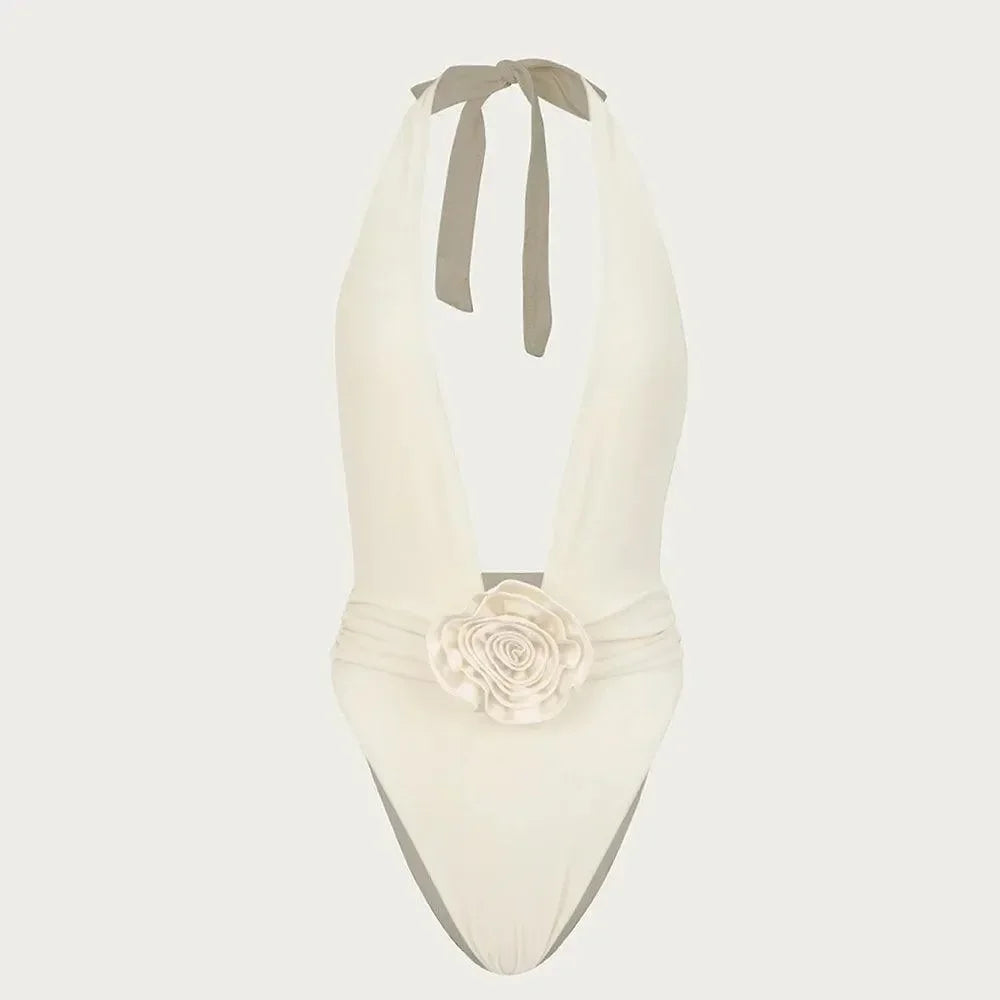 Elegant white one-piece swimsuit featuring a deep V-neck and a soft rose detail at the waist, tied stylishly at the back.