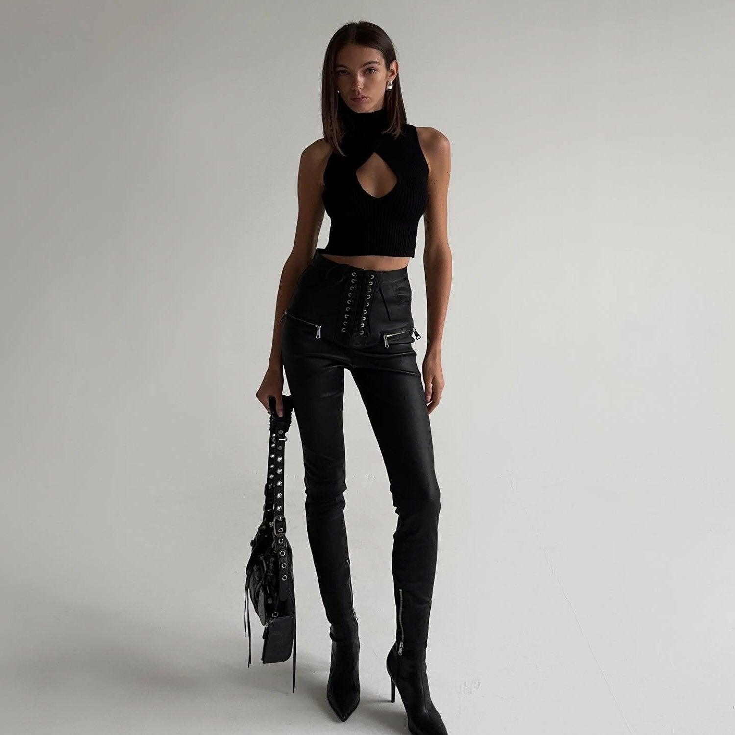 black cutout crop top and high-waisted lace-up pants, night-out style
