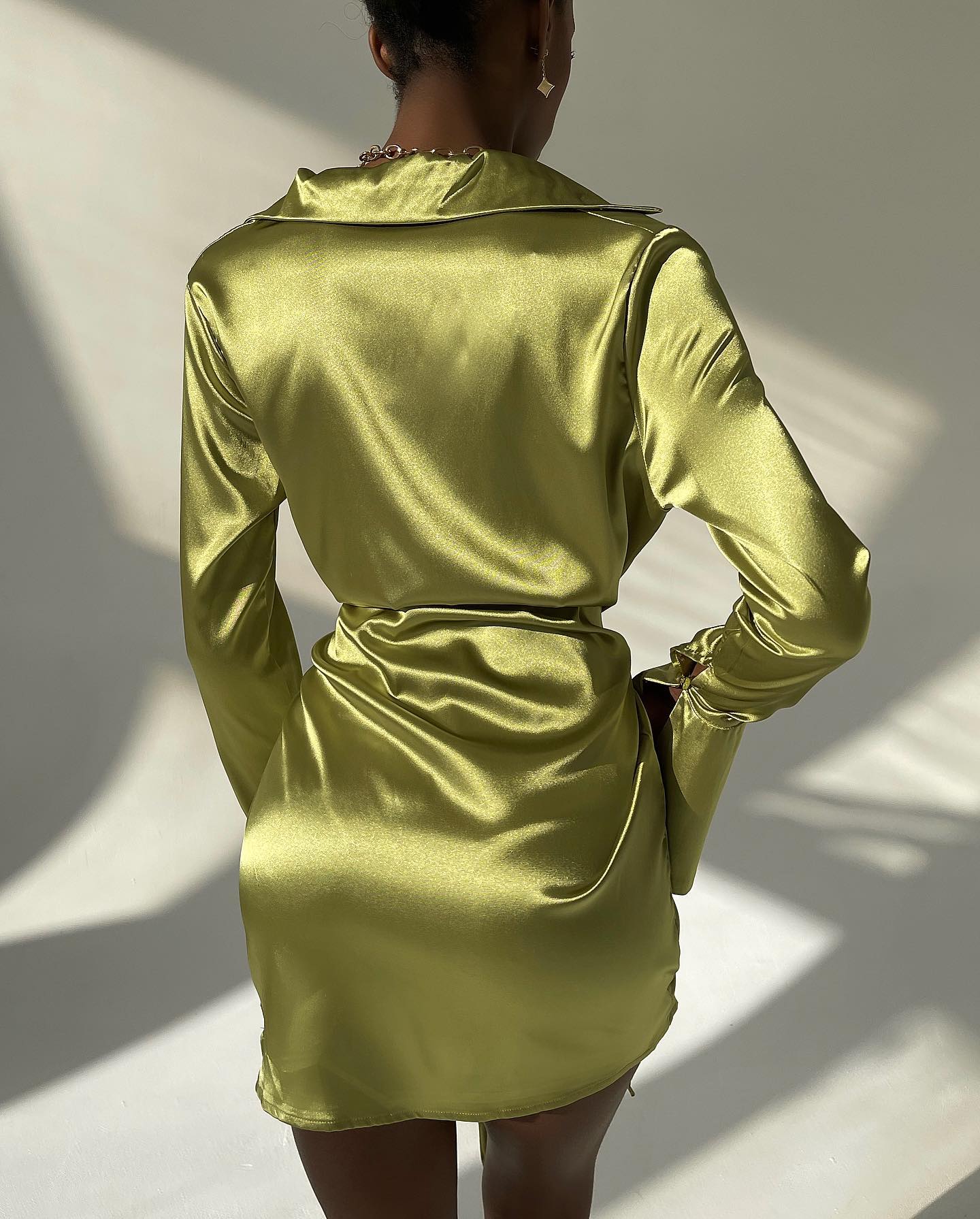 Jamaica green satin mini dress with long sleeves, collared neckline, and belted waist, perfect for elegant evening events.