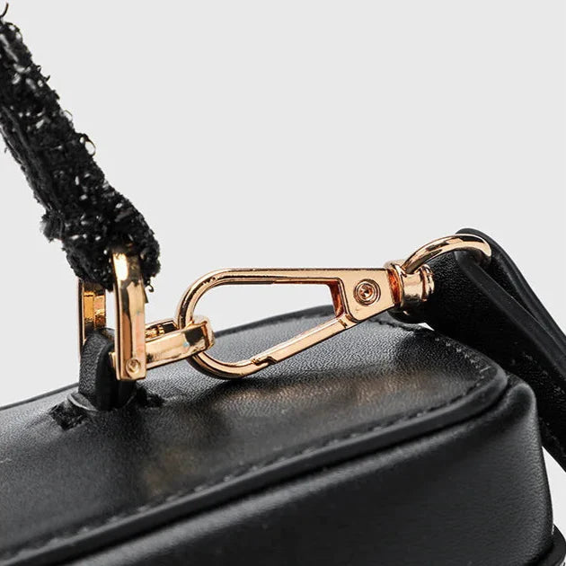 black handbag with detachable gold chain strap