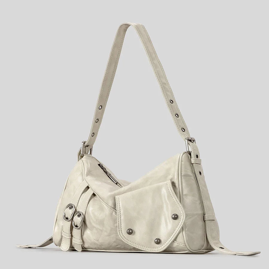 Cream shoulder bag with buckle and stud details.