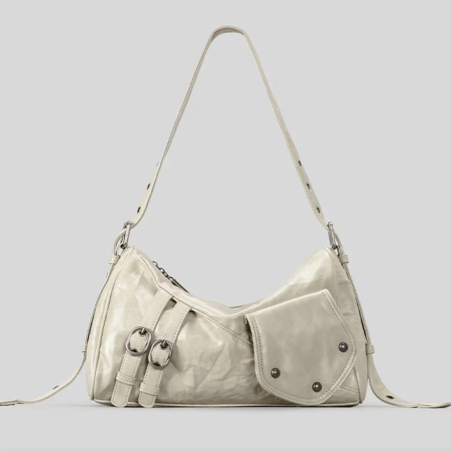 Cream leather shoulder bag with buckle and pocket details.