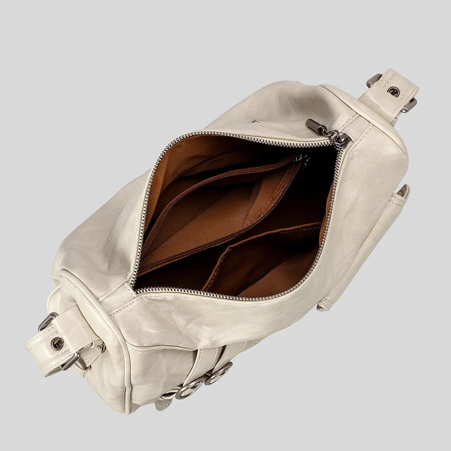 cream leather bag with silver hardware and multiple compartments