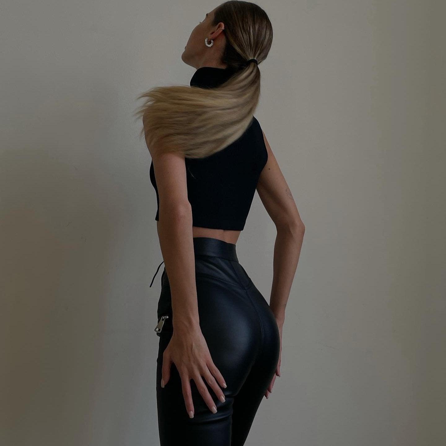 black sleeveless crop top and high-waisted leather pants, night-out look