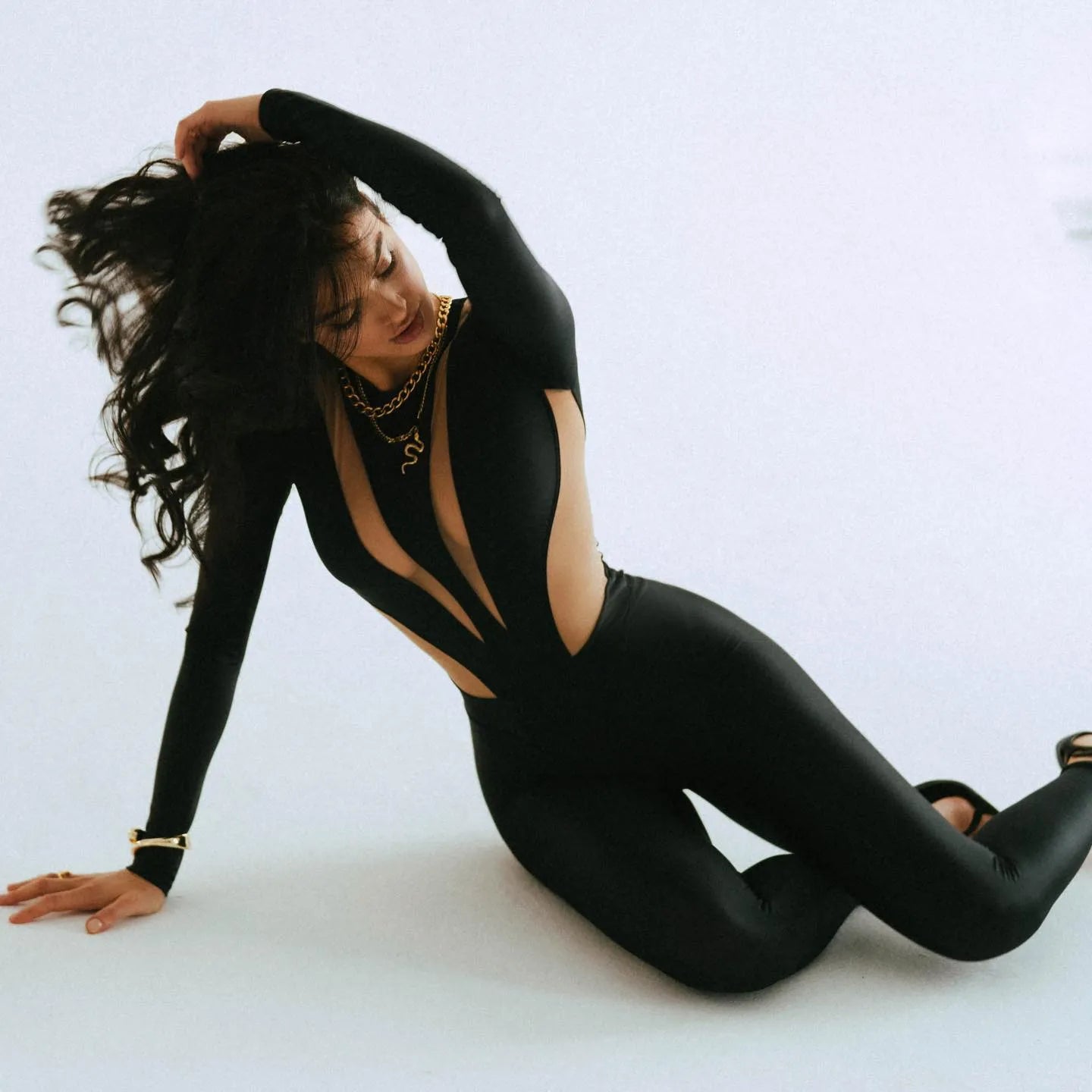 black long-sleeve cut-out jumpsuit, night-out style