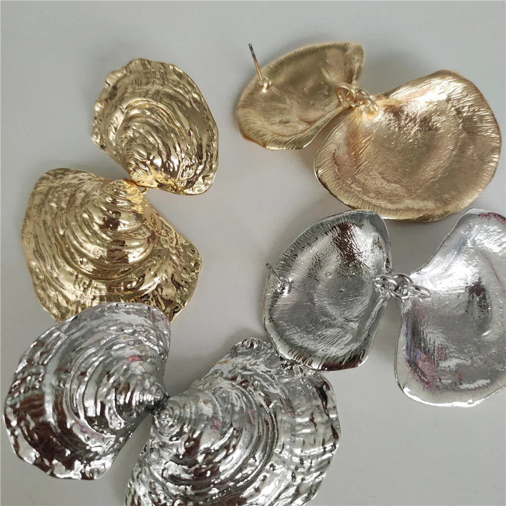 metallic shell earrings in gold and silver, statement accessory