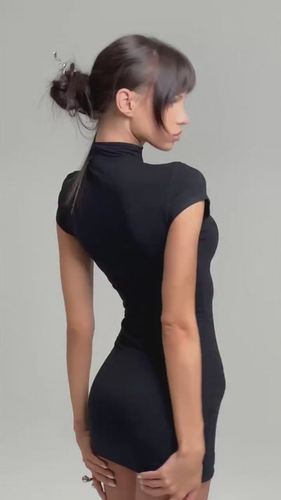 Woman wearing a black dress against a white background