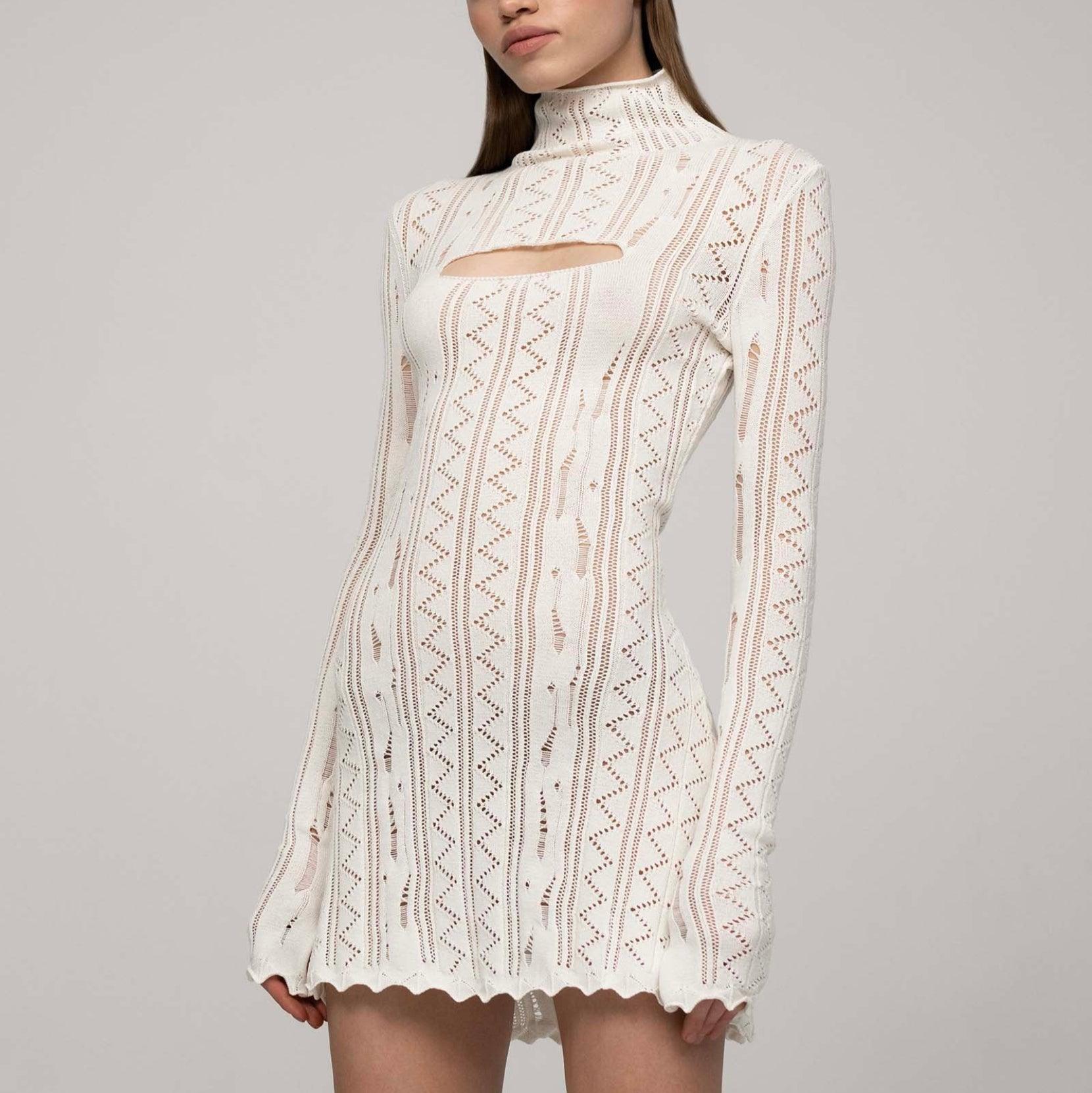 White knitted mini dress with long sleeves, featuring a stylish cut-out and ribbed details, perfect for a chic casual look.