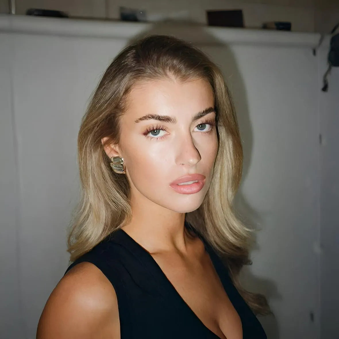 Black sleeveless top with a deep V-neck.