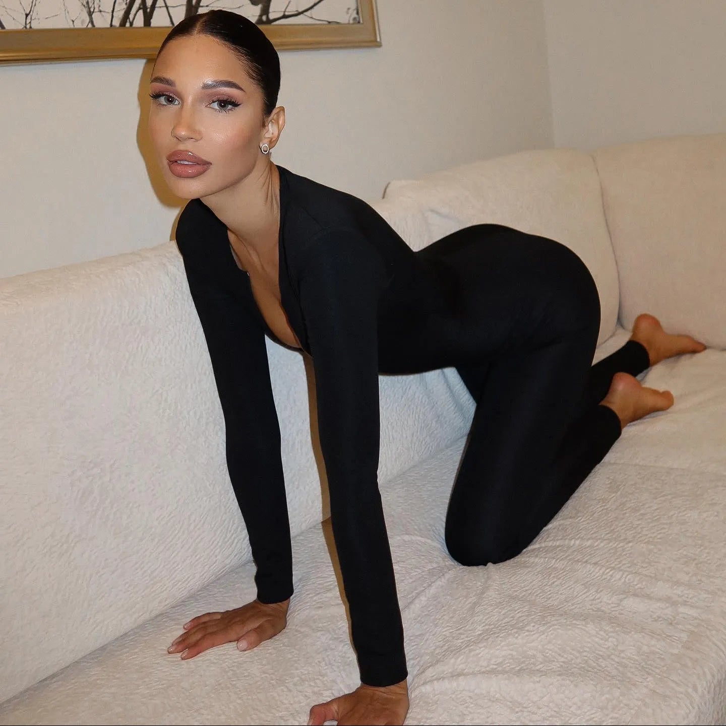 black long-sleeve bodycon jumpsuit, night-out style