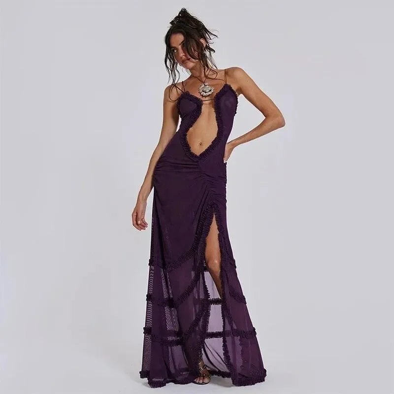 Ruched purple maxi dress with a daring cutout and thigh-high slit, styled with layered necklaces and strappy heels.