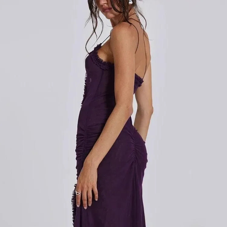 Ruched purple maxi dress with adjustable spaghetti straps, form-fitting silhouette, elegantly styled for evening wear.