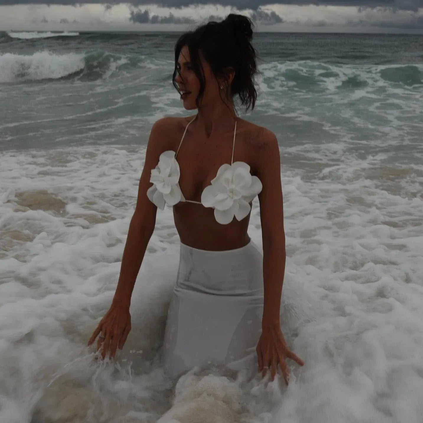 floral embellished bikini top and white high-waisted skirt, beachwear style