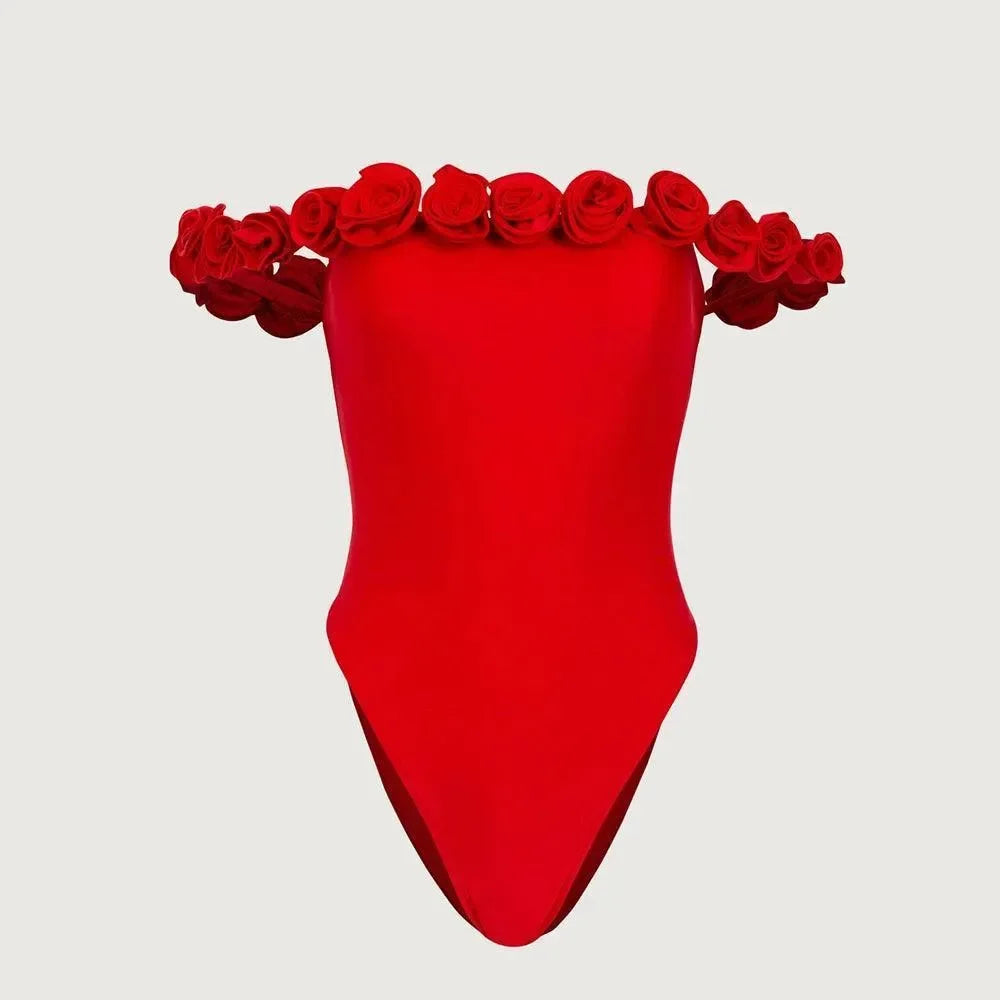 Bright red off-shoulder swimsuit featuring floral appliqué at the neckline, perfect for a stylish beach look.