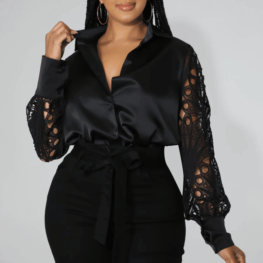 Black lace satin blouse with button-up front and intricate lace sleeves, styled with high-waisted trousers for a chic look.