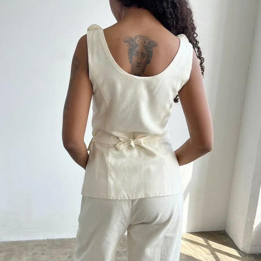 beige sleeveless top with bow detail