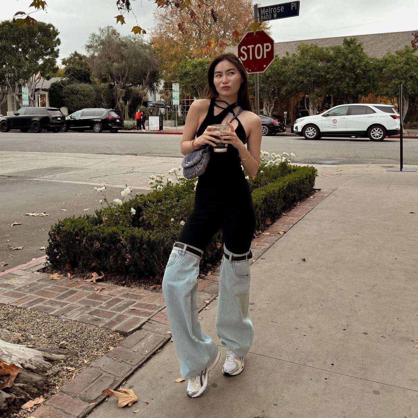 Black halter top with flared denim jeans.