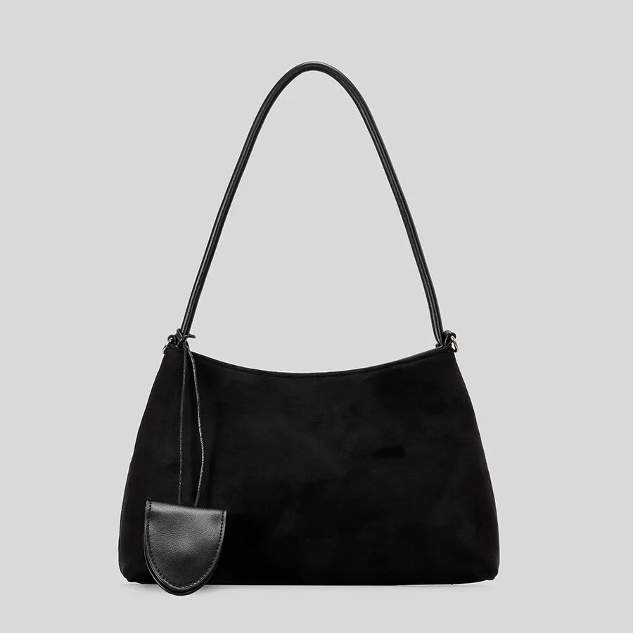 black suede shoulder bag with leather tag