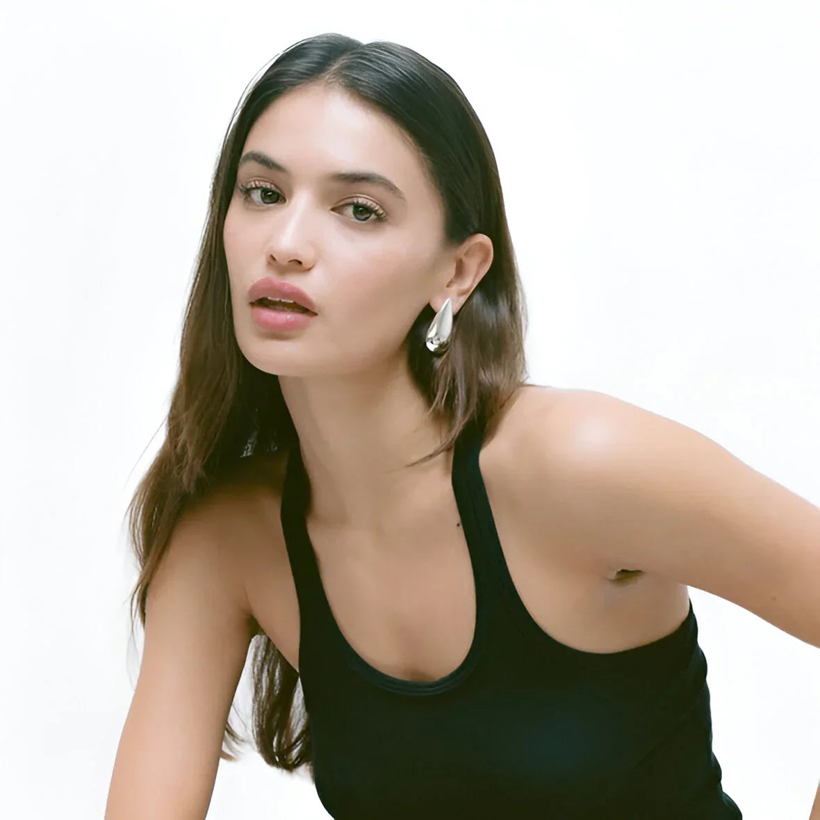 black tank top with silver earrings