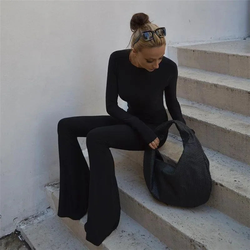 black long-sleeve top and flared pants set with oversized bag, casual chic outfit