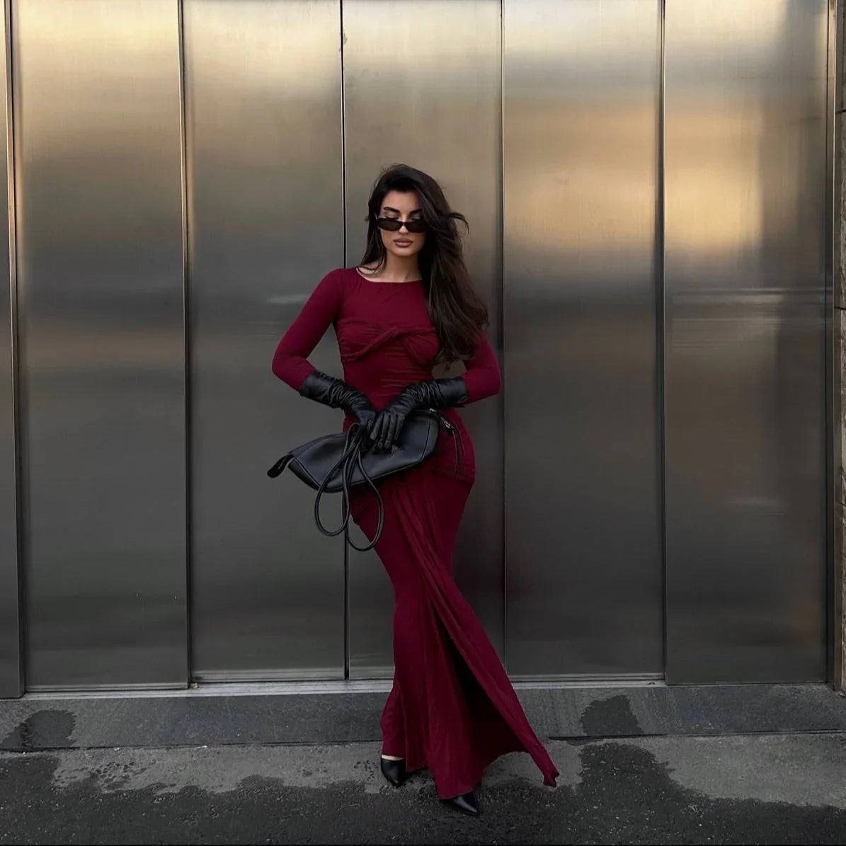 burgundy maxi dress with long sleeves and black accessories, evening wear